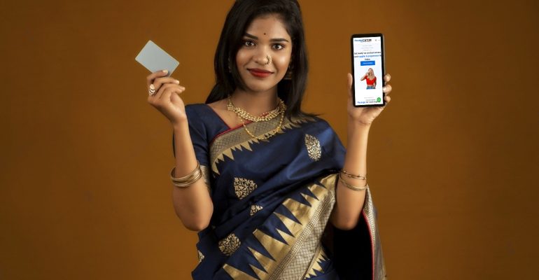 -young-smiling-beautiful-woman-or-girl-presenting-credit-card-while-using-mobile-or-smartphone-2104537283-transformed